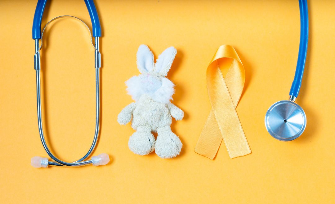 A stethoscope, a stuffed rabbit and a yellow ribbon