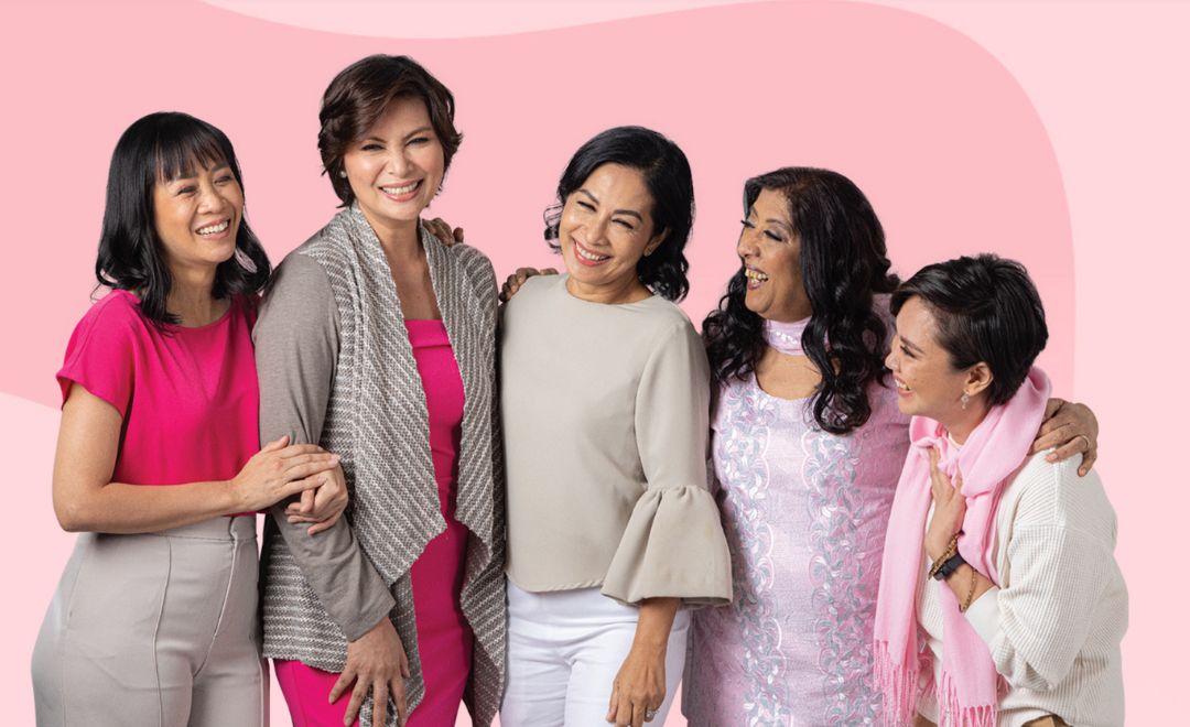 A group of southeast Asian women smiling on a pink background
